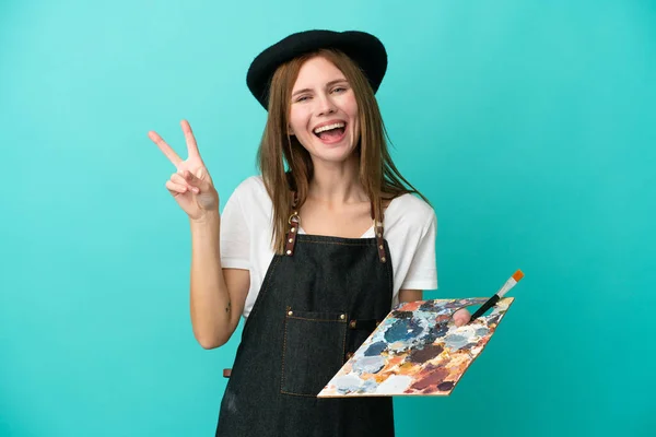 Młoda Artystka Angielski Kobieta Trzyma Paletę Odizolowanych Niebieskim Tle Uśmiechając — Zdjęcie stockowe