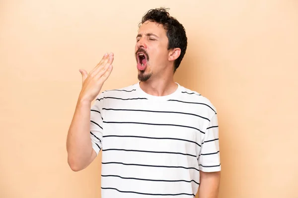 Young Caucasian Man Isolated Beige Background Yawning Covering Wide Open — Stock Photo, Image