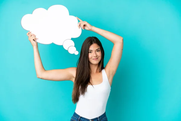 stock image Young Brazilian woman isolated on blue background holding a thinking speech bubble