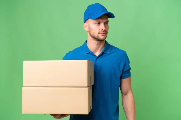 stock image Delivery caucasian man over isolated background looking to the side