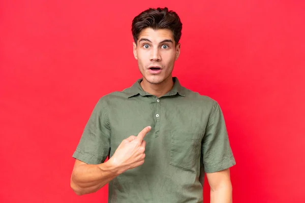 stock image Young caucasian handsome man isolated on red background pointing to oneself