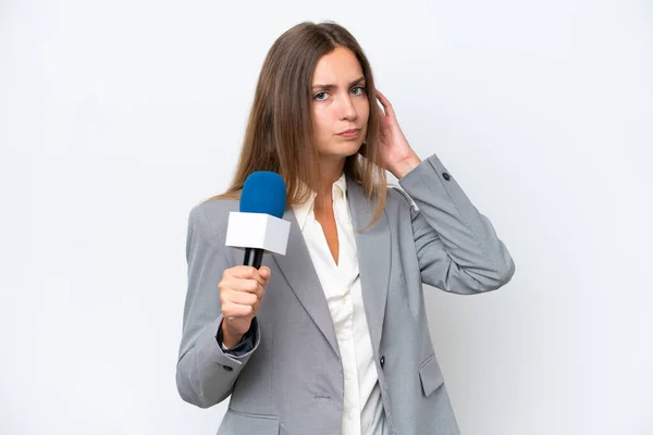 stock image Young TV presenter caucasian woman isolated on white background having doubts