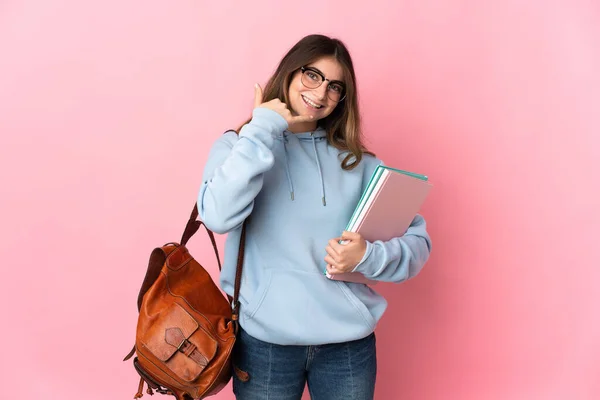 stock image Young student woman isolated on pink background making phone gesture. Call me back sign