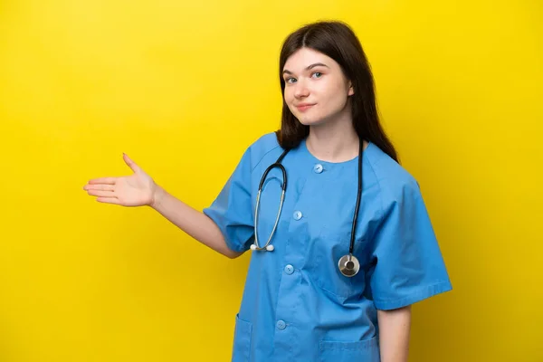 Young Surgeon Doctor Russian Woman Isolated Yellow Background Extending Hands — Stockfoto