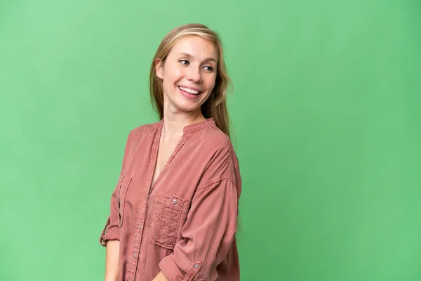 stock image Young blonde woman over isolated background looking to the side and smiling