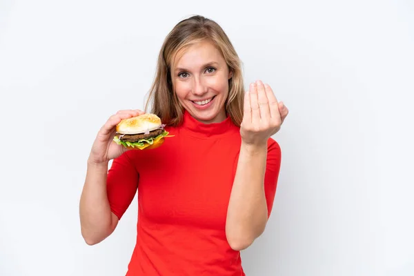 Młoda Blondynka Trzymająca Hamburgera Odizolowanego Białym Tle Zapraszając Przyjścia Ręką — Zdjęcie stockowe