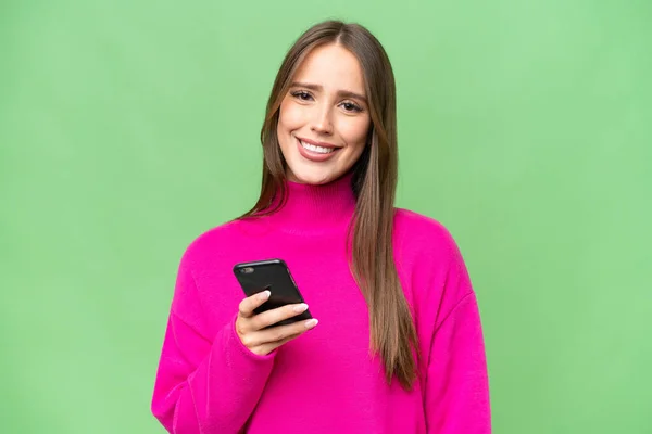 Jovem Bela Mulher Caucasiana Sobre Fundo Isolado Usando Telefone Celular — Fotografia de Stock