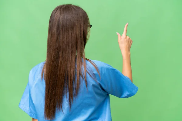 Young Nurse Caucasian Woman Isolated Background Pointing Back Index Finger — Stock Photo, Image