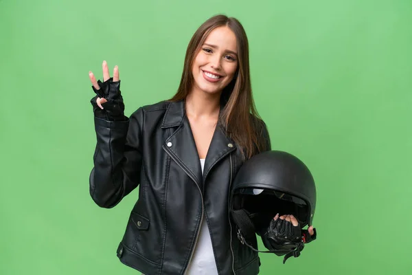 若いです可愛いですCaucasian女性とともにオートバイヘルメット上の隔離された背景幸せとカウント3とともに指 — ストック写真