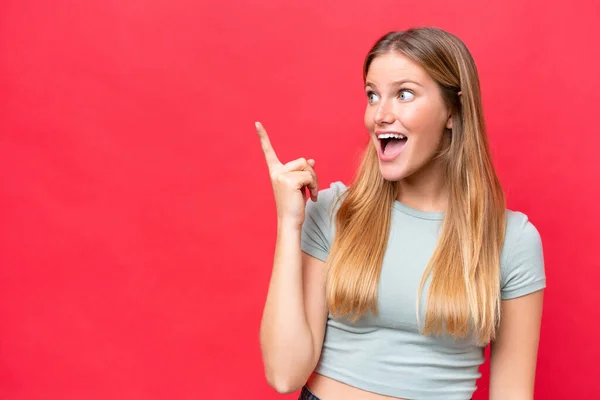 stock image Young beautiful woman isolated on red background intending to realizes the solution while lifting a finger up