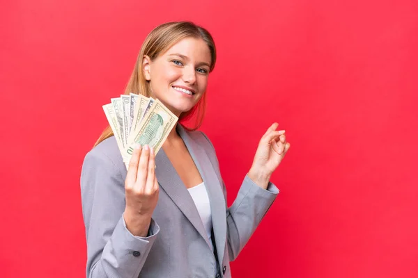 Young Business Caucasian Woman Holding Money Isolated Red Background Pointing — Stock Photo, Image