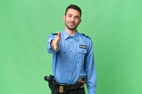 Jovem Polícia Caucasiano Homem Sobre Fundo Isolado Apertando Mãos Para — Fotografia de Stock