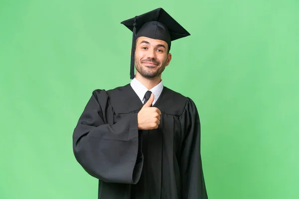 Jovem Universitário Graduado Homem Sobre Isolado Fundo Dando Polegares Para — Fotografia de Stock