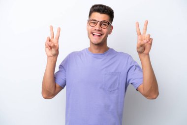 Young caucasian man isolated on white background showing victory sign with both hands