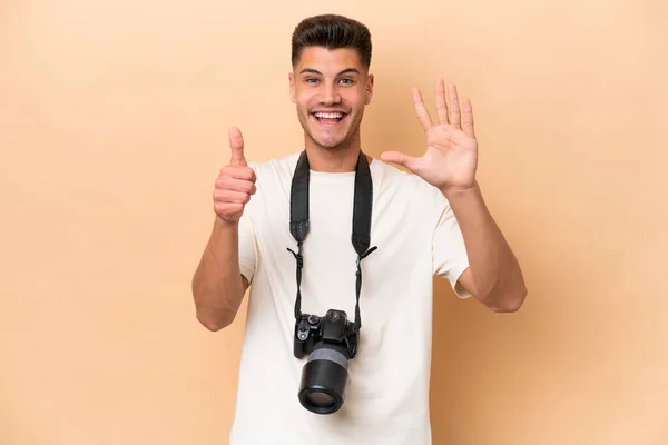 Young Photographer Caucasian Man Isolated Beige Background Counting Six Fingers — Stock Photo, Image