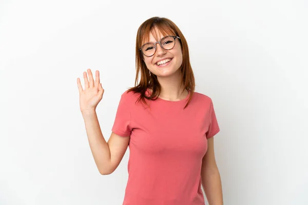 stock image Redhead girl isolated on white background saluting with hand with happy expression