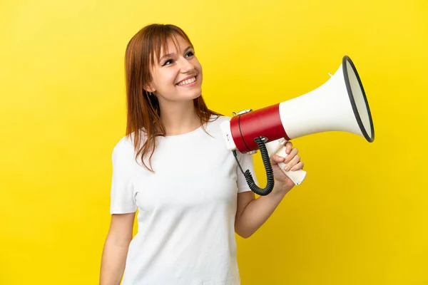 Redhead Girl Isolated Yellow Background Holding Megaphone Looking While Smiling — Stock Photo, Image