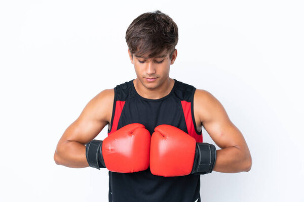 Young caucasian man isolated on white background with boxing gloves