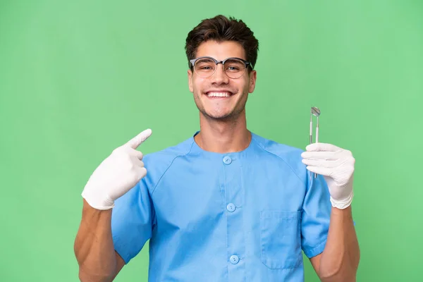 Jovem Dentista Homem Segurando Ferramentas Sobre Fundo Isolado Dando Gesto — Fotografia de Stock