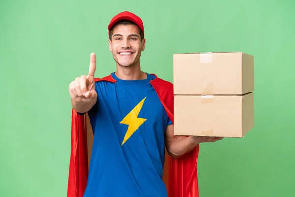 Super Hero Delivery Man Isolated Background Showing Lifting Finger — Stock Photo, Image