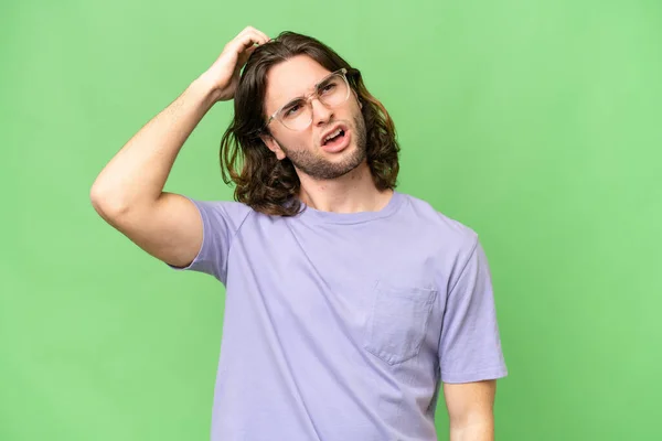 stock image Young handsome man over isolated background having doubts while scratching head