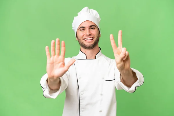 Genç Yakışıklı Aşçı Izole Edilmiş Arka Planda Yediyi Parmaklarıyla Sayıyor — Stok fotoğraf