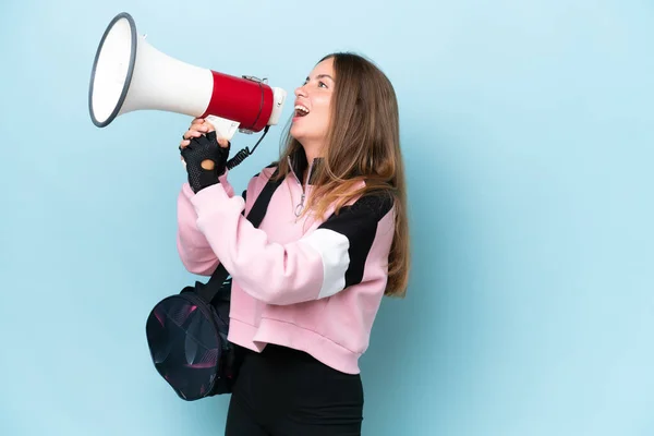 Young Sport Woman Sport Bag Isolated Blue Background Shouting Megaphone —  Fotos de Stock