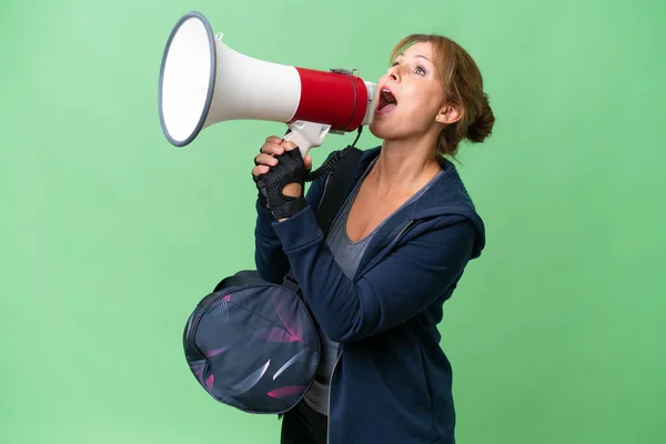Middle Aged Sport Woman Sport Bag Isolated Background Shouting Megaphone — Stock Photo, Image