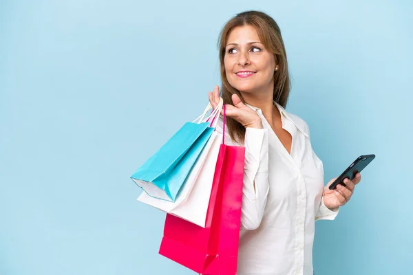 Middle Aged Caucasian Woman Isolated Blue Background Holding Shopping Bags — Stock Photo, Image