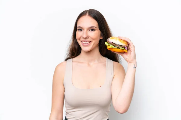 Young Caucasian Woman Holding Burger Isolated White Background Smiling Lot — Stock Photo, Image