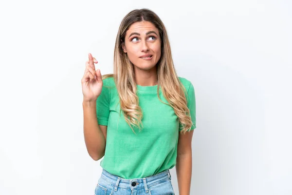 stock image Young Uruguayan woman isolated on white background with fingers crossing and wishing the best