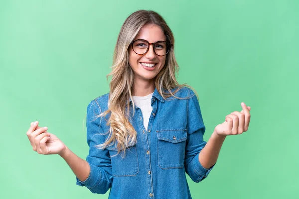 stock image Young Uruguayan woman over isolated background making money gesture