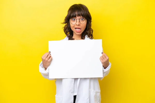 stock image Young doctor latin woman isolated on yellow background holding an empty placard with happy expression