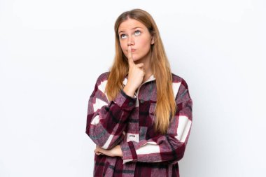 Beyaz arka planda izole edilmiş genç beyaz kadın yukarı bakarken şüpheleri var.