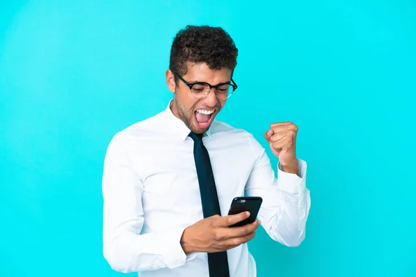 Young Business Brazilian Man Isolated Blue Background Phone Victory Position — Stock Photo, Image