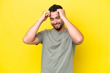 Young Arab handsome man isolated on yellow background laughing