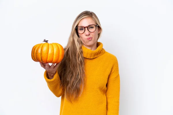 stock image Young blonde woman holding a pumpkin isolated on white background with sad expression