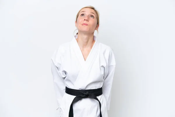 stock image Young caucasian woman doing karate isolated on white background and looking up