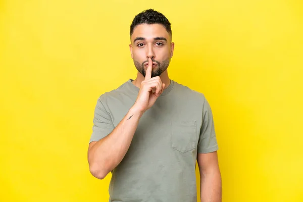 stock image Young Arab handsome man isolated on yellow background showing a sign of silence gesture putting finger in mouth