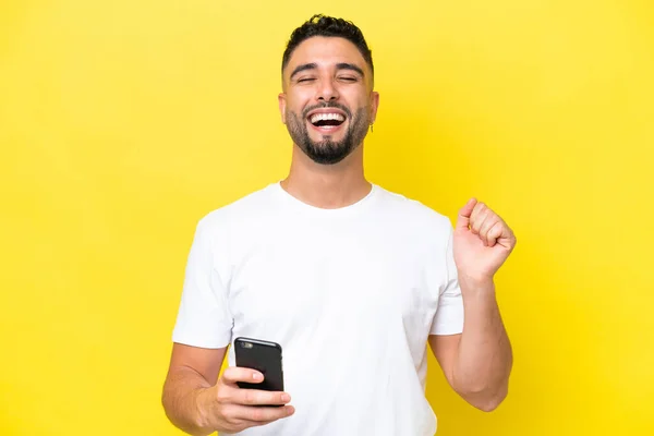 Young Arab Handsome Man Isolated Yellow Background Using Mobile Phone — Stockfoto