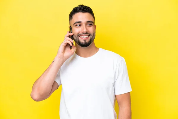 Young Arab Handsome Man Isolated Yellow Background Keeping Conversation Mobile — 스톡 사진