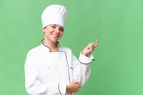 young chef woman over isolated green background 