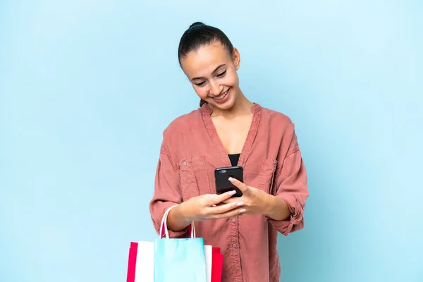 Young Arab Woman Isolated Blue Background Holding Shopping Bags Writing — Stock Photo, Image