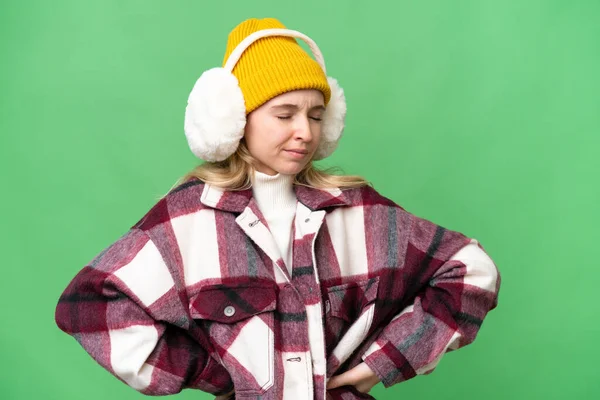年轻的英国女人穿着冬衣 背景偏僻 背痛难忍 因为她付出了努力 — 图库照片
