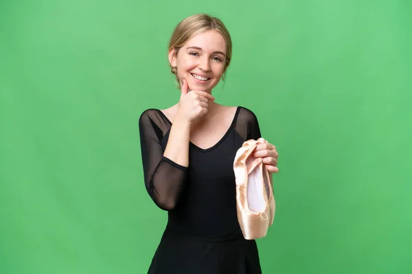 Young English woman practicing ballet over isolated background happy and smiling