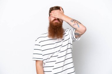 Kızıl saçlı, sakallı bir adam beyaz arka planda, gözleri elleriyle kapatıyor. Bir şey görmek istemiyorum.