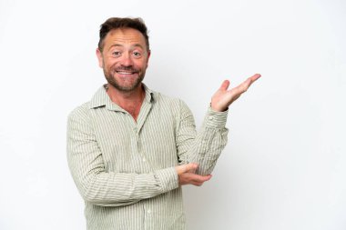 Middle age caucasian man isolated on white background extending hands to the side for inviting to come