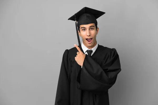 Young Argentinian University Graduate Isolated Grey Background Surprised Pointing Side — Stock Photo, Image