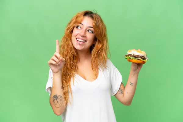 Young Caucasian Woman Holding Burger Isolated Green Screen Chroma Key — Stock Photo, Image