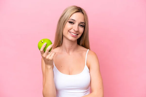 Hübsche Blonde Frau Isoliert Auf Rosa Hintergrund Mit Einem Apfel — Stockfoto
